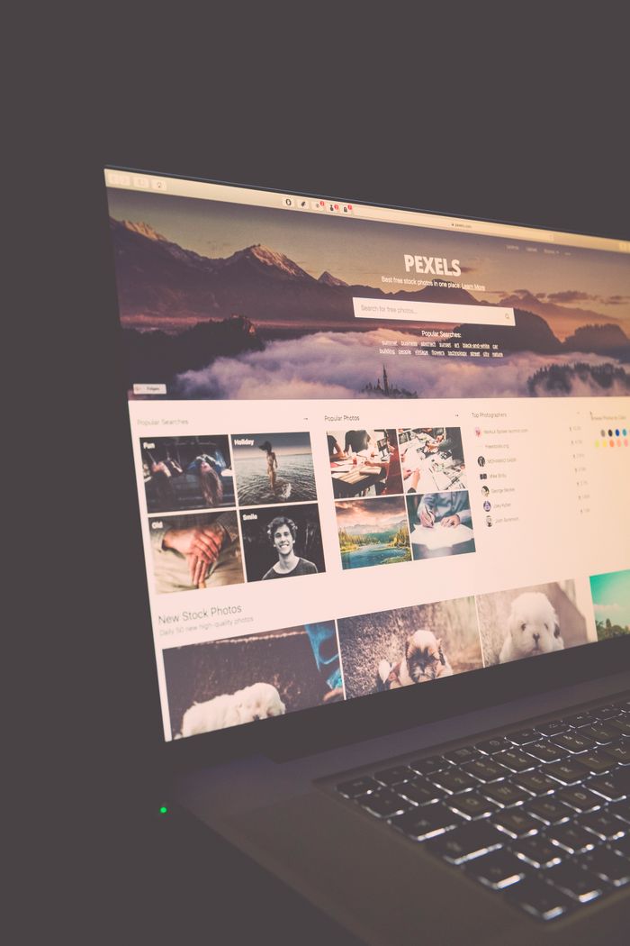 A laptop screen displaying the Pexels website, perfect for stock photo needs.